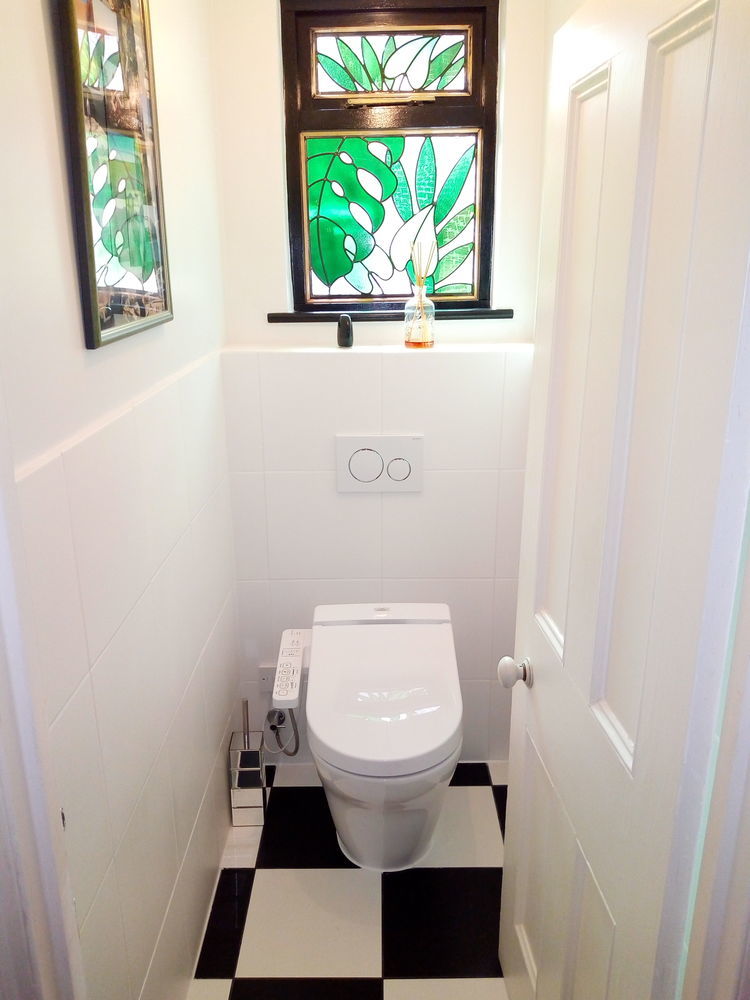 WC with stained glass window and checkerboard floor