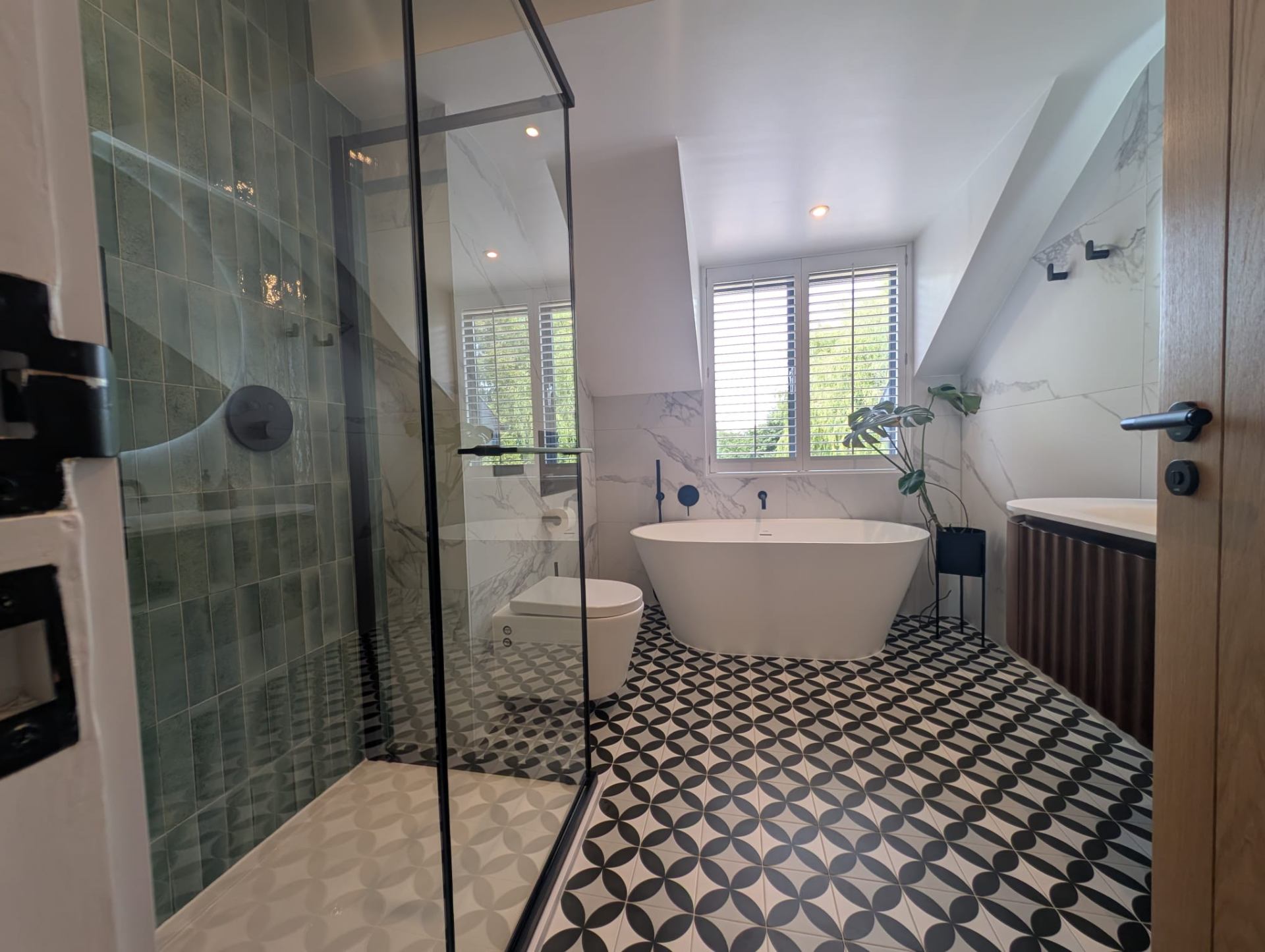 Bathroom with freestanding bath, walk-in shower and patterned floor