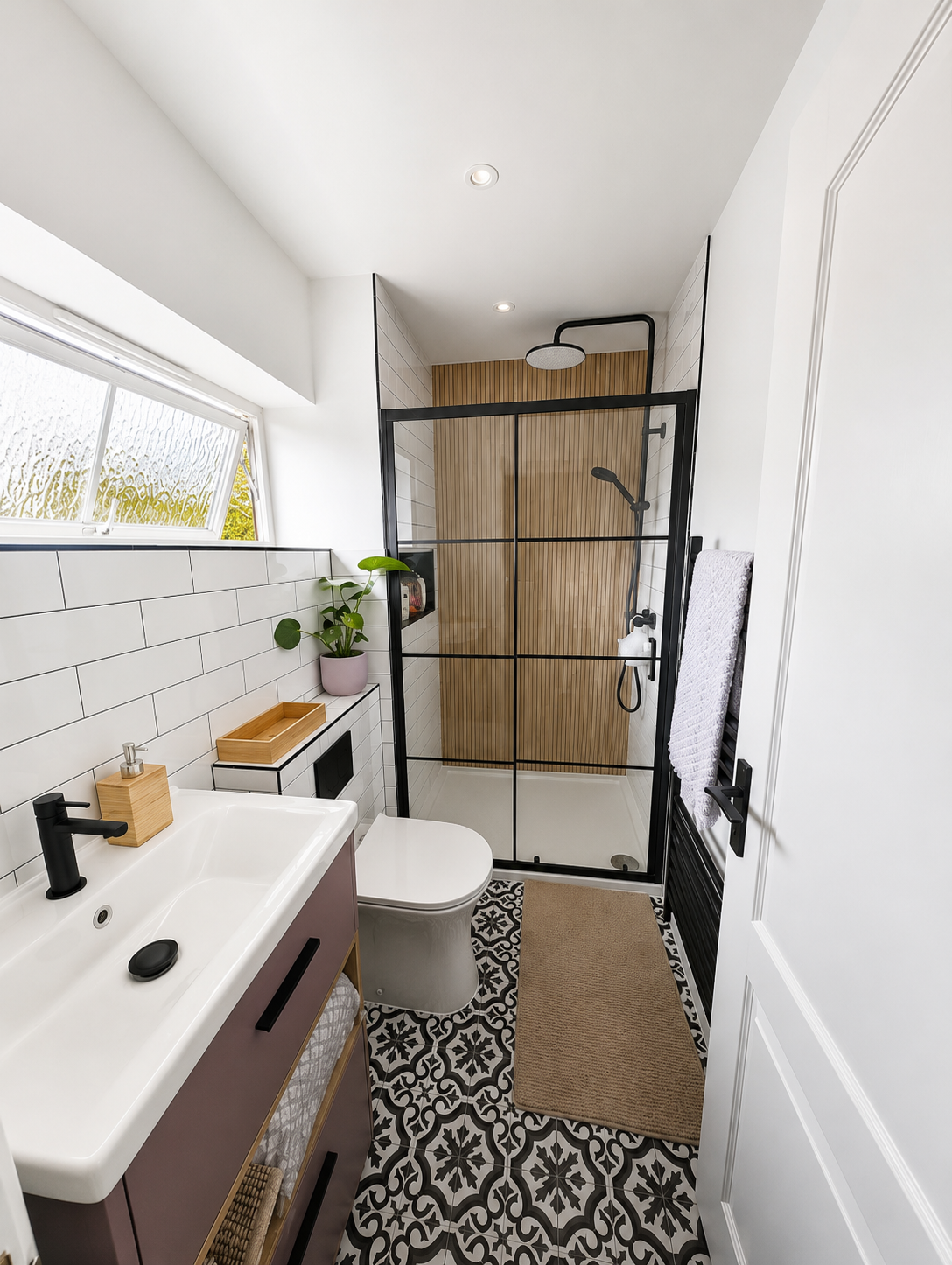 Compact bathroom with walk-in shower, wood panelling and patterned floor tiles